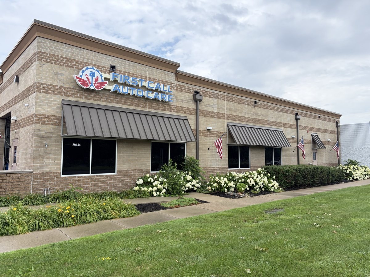 The First Call Auto Care building at 29444 Woodward Avenue in Royal Oak, MI, with the lit sign above the entrance