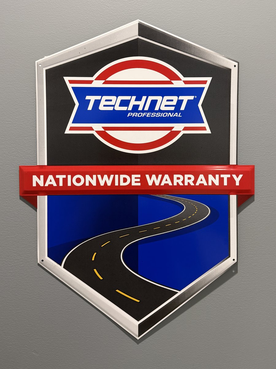 The TechNet Professional Nationwide Warranty sign on the wall at First Call Auto Care in Royal Oak, MI